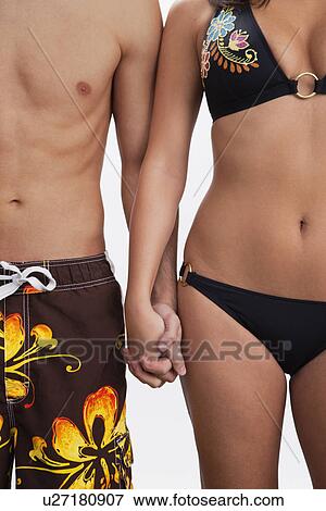 USA, Illinois, Metamora, Midsection of couple holding hands View Large Photo Image Stock Photo - USA, Illinois, Metamora, Midsection of couple holding hands. Fotosearch