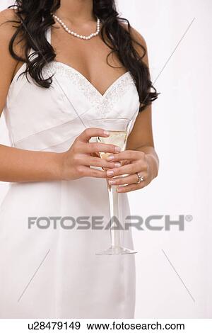 USA, Illinois, Metamora, Midsection of bride holding champagne flute View Large Photo Image Stock Photo - USA, Illinois, Metamora, Midsection of bride holding champagne flute. Fotosearch