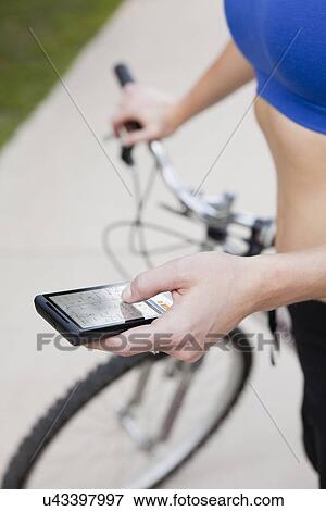 Stock Photo - USA, Illinois, Metamora, midsection of woman text-messaging. Fotosearch