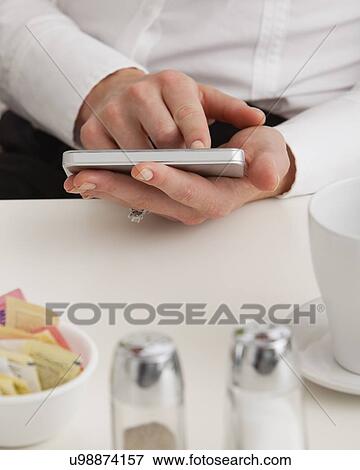 Stock Photo - USA, Illinois, Metamora, Midsection of woman using tablet pc. Fotosearch