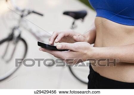 USA, Illinois, Metamora, midsection of woman text-messaging View Large Photo Image Stock Photograph - USA, Illinois, Metamora, midsection of woman text-messaging. Fotosearch
