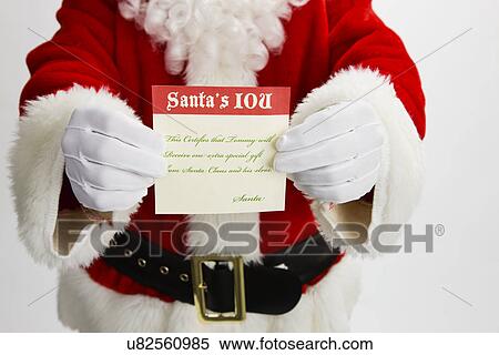 Stock Photography - USA, Illinois, Metamora, Midsection of Santa Claus holding iou agreement. Fotosearch
