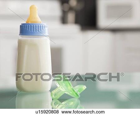 Stock Photo - USA, Illinois, Metamora, Milk bottle and pacifier. Fotosearch