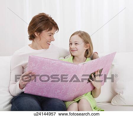 USA, Illinois, Metamora, Mother and daughter (8-9) looking at photo album together View Large Photo Image Stock Photo - USA, Illinois, Metamora, Mother and daughter (8-9) looking at photo album together. Fotosearch