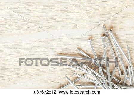 Stock Image - USA, Illinois, Metamora, Nails on wood. Fotosearch