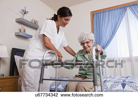 USA, Illinois, Metamora, Nurse helping senior woman with walker View Large Photo Image Stock Image - USA, Illinois, Metamora, Nurse helping senior woman with walker. Fotosearch