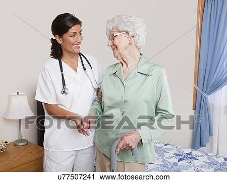 USA, Illinois, Metamora, Nurse helping senior woman with cane View Large Photo Image Stock Image - USA, Illinois, Metamora, Nurse helping senior woman with cane. Fotosearch
