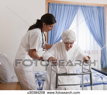 USA, Illinois, Metamora, Nurse helping senior woman with walker View Large Photo Image Stock Photo - USA, Illinois, Metamora, Nurse helping senior woman with walker. Fotosearch