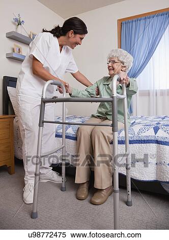 USA, Illinois, Metamora, Nurse helping senior woman with walker View Large Photo Image Stock Photography - USA, Illinois, Metamora, Nurse helping senior woman with walker. Fotosearch