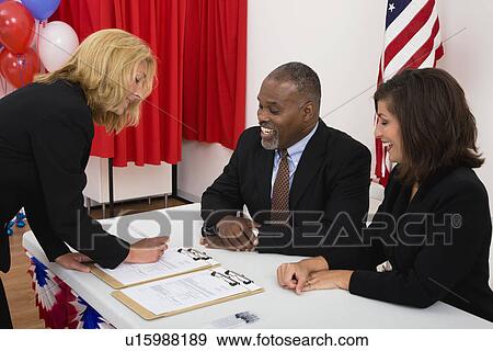 USA, Illinois, Metamora, People at polling place table, US flag, balloons and voting booth in background View Large Photo Image Stock Photo - USA, Illinois, Metamora, People at polling place table, US flag, balloons and voting booth in background. Fotosearch
