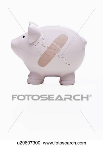 Stock Image - USA, Illinois, Metamora, Piggy bank with crack and bandage. Fotosearch
