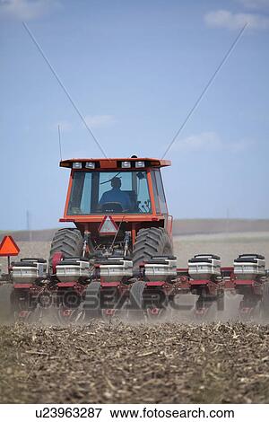 Stock Photo - USA, Illinois, Metamora, plough working on field. Fotosearch