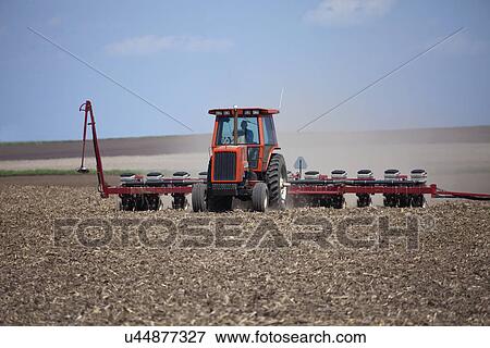 Stock Photo - USA, Illinois, Metamora, plough working on field. Fotosearch