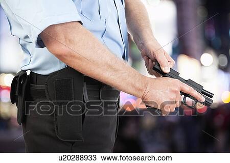 USA, Illinois, Metamora, Police officer reloading gun View Large Photo Image Stock Image - USA, Illinois, Metamora, Police officer reloading gun. Fotosearch