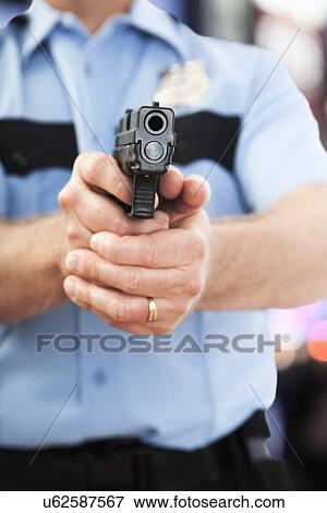 USA, Illinois, Metamora, Police officer aiming gun View Large Photo Image Stock Photo - USA, Illinois, Metamora, Police officer aiming gun. Fotosearch