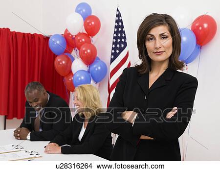 USA, Illinois, Metamora, Portrait of woman at polling place, US flag, balloons and voting booth in background View Large Photo Image Picture - USA, Illinois, Metamora, Portrait of woman at polling place, US flag, balloons and voting booth in background. Fotosearch