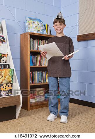 Stock Image - USA, Illinois, Metamora, Portrait of school boy (8-9) in classroom. Fotosearch