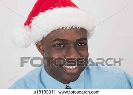 USA, Illinois, Metamora, Portrait of smiling man in Santa hat View Large Photo Image Stock Image - USA, Illinois, Metamora, Portrait of smiling man in Santa hat. Fotosearch