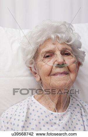 Stock Image - USA, Illinois, Metamora, Portrait of senior woman wearing oxygen tubes. Fotosearch