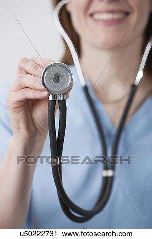 Stock Image - USA, Illinois, Metamora, Portrait of smiling female doctor. Fotosearch