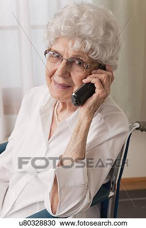 USA, Illinois, Metamora, Portrait of smiling senior woman on wheelchair talking on phone View Large Photo Image Stock Image - USA, Illinois, Metamora, Portrait of smiling senior woman on wheelchair talking on phone. Fotosearch