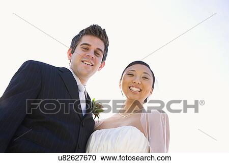 Stock Image - USA, Illinois, Metamora, Portrait of bride and groom. Fotosearch
