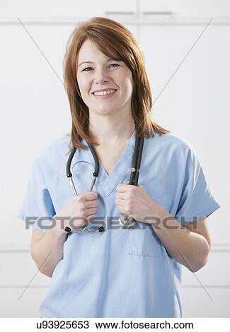Stock Image - USA, Illinois, Metamora, Portrait of smiling female doctor. Fotosearch