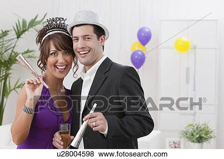 USA, Illinois, Metamora, Portrait of couple at New Year's Eve party View Large Photo Image Stock Photo - USA, Illinois, Metamora, Portrait of couple at New Year's Eve party. Fotosearch
