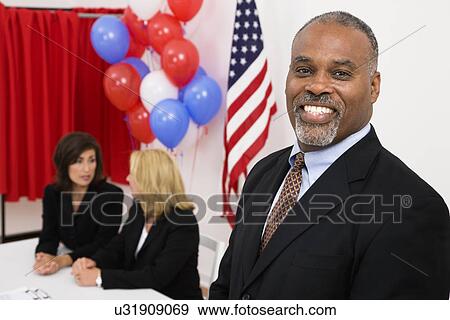 USA, Illinois, Metamora, Portrait of man at polling place, US flag, balloons and voting booth in background View Large Photo Image Stock Photo - USA, Illinois, Metamora, Portrait of man at polling place, US flag, balloons and voting booth in background. Fotosearch