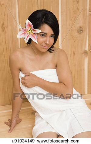 Stock Photo - USA, Illinois, Metamora, Portrait of young woman in sauna. Fotosearch