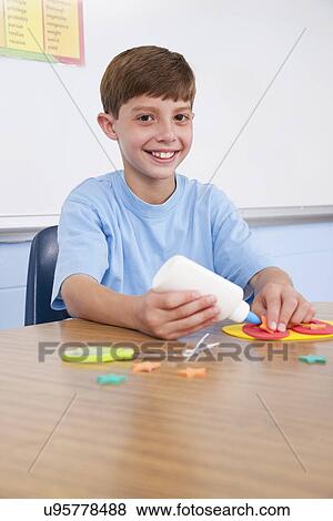 USA, Illinois, Metamora, Portrait of school boy (8-9) in classroom View Large Photo Image Stock Photo - USA, Illinois, Metamora, Portrait of school boy (8-9) in classroom. Fotosearch