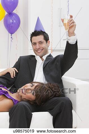 Stock Photo - USA, Illinois, Metamora, Portrait of couple at New Year's Eve party. Fotosearch