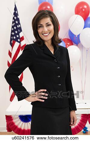 Stock Photograph - USA, Illinois, Metamora, Portrait of smiling woman in front of US flag and balloons. Fotosearch