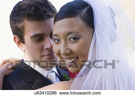 Stock Photograph - USA, Illinois, Metamora, Portrait of bride and groom. Fotosearch