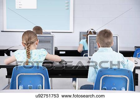 USA, Illinois, Metamora, Rear view of children (8-9, 10-11) using laptops in computer lab View Large Photo Image Stock Image - USA, Illinois, Metamora, Rear view of children (8-9, 10-11) using laptops in computer lab. Fotosearch