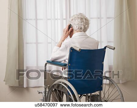 USA, Illinois, Metamora, Rear view of senior woman on wheelchair talking on phone View Large Photo Image Stock Photo - USA, Illinois, Metamora, Rear view of senior woman on wheelchair talking on phone. Fotosearch