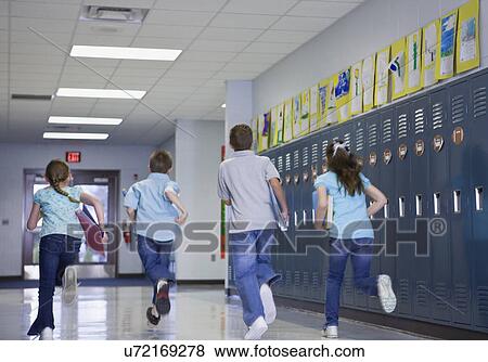 USA, Illinois, Metamora, Rear view of children (8-9, 10-11) running through school corridor View Large Photo Image Stock Photo - USA, Illinois, Metamora, Rear view of children (8-9, 10-11) running through school corridor. Fotosearch