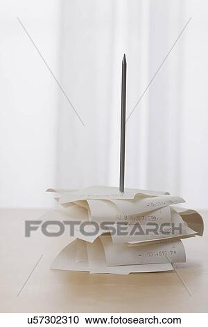 Stock Image - USA, Illinois, Metamora, Receipts on desk in office. Fotosearch