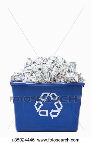 Stock Photograph - USA, Illinois, Metamora, Recycling bin full of US money. Fotosearch