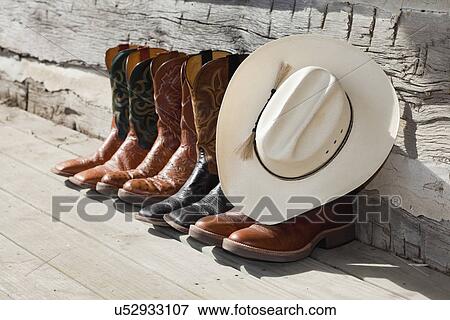 Stock Photo - USA, Illinois, Metamora, Row of cowboy boots and cowboy hat. Fotosearch