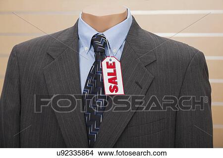 Picture - USA, Illinois, Metamora, Sale tag on suit in shop. Fotosearch