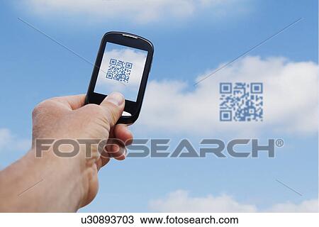 Stock Image - USA, Illinois, Metamora, Sample of using smart phone device. Fotosearch