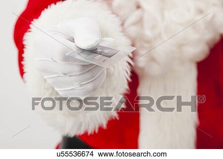 Picture - USA, Illinois, Metamora, Santa claus holding credit card. Fotosearch