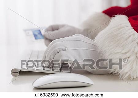 USA, Illinois, Metamora, Santa claus shopping with computer and credit card View Large Photo Image Stock Image - USA, Illinois, Metamora, Santa claus shopping with computer and credit card. Fotosearch