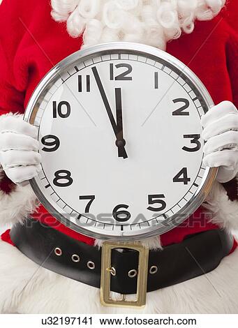 USA, Illinois, Metamora, Santa claus holding large clock View Large Photo Image Stock Image - USA, Illinois, Metamora, Santa claus holding large clock. Fotosearch