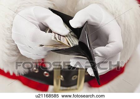 USA, Illinois, Metamora, Santa claus counting money in wallet View Large Photo Image Stock Photography - USA, Illinois, Metamora, Santa claus counting money in wallet. Fotosearch