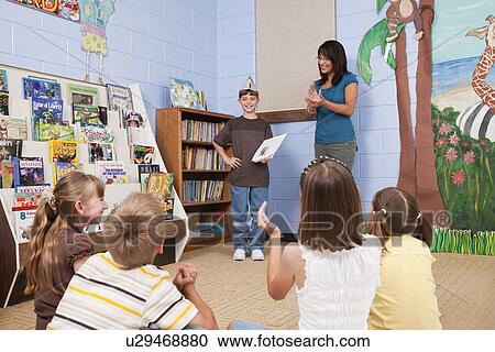USA, Illinois, Metamora, School boy (8-9) presenting work to class View Large Photo Image Stock Image - USA, Illinois, Metamora, School boy (8-9) presenting work to class . Fotosearch