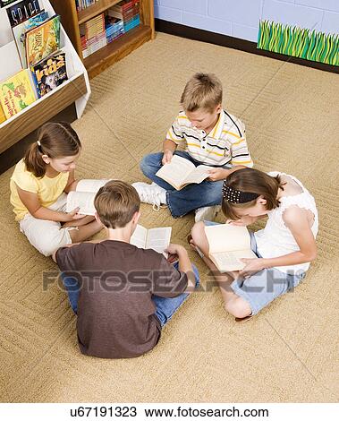 USA, Illinois, Metamora, School children (8-9) reading on floor in school View Large Photo Image Stock Image - USA, Illinois, Metamora, School children (8-9) reading on floor in school. Fotosearch