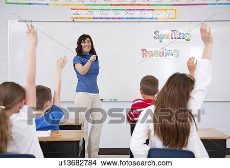 USA, Illinois, Metamora, Schoolchildren (8-9, 10-11) and female teacher in classroom View Large Photo Image Picture - USA, Illinois, Metamora, Schoolchildren (8-9, 10-11) and female teacher in classroom. Fotosearch