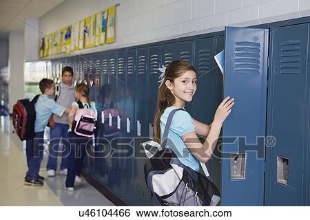 Stock Photograph - USA, Illinois, Metamora, Schoolchildren (8-9, 10-11) at lockers in school corridor. Fotosearch